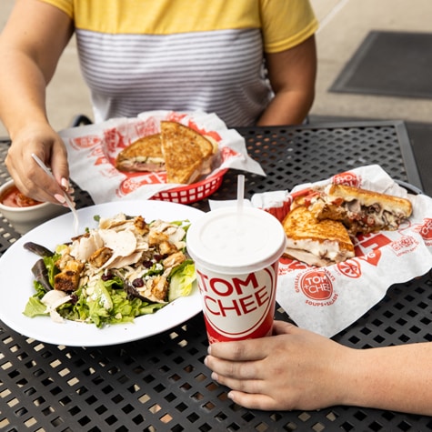 Two diners at a table enjoying their meals.